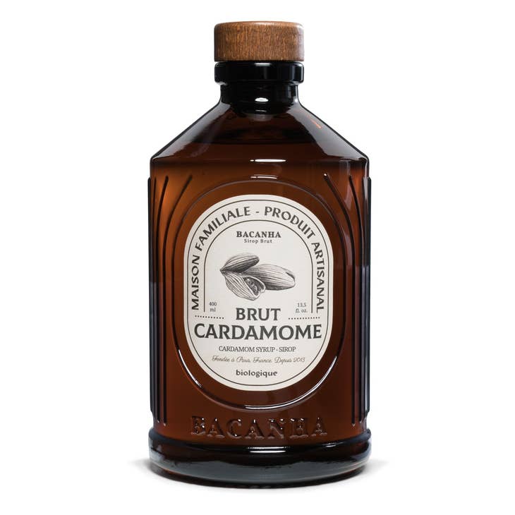 Brown bottle of Bacanna Brut Cardamome syrup with a wooden cap on a white background