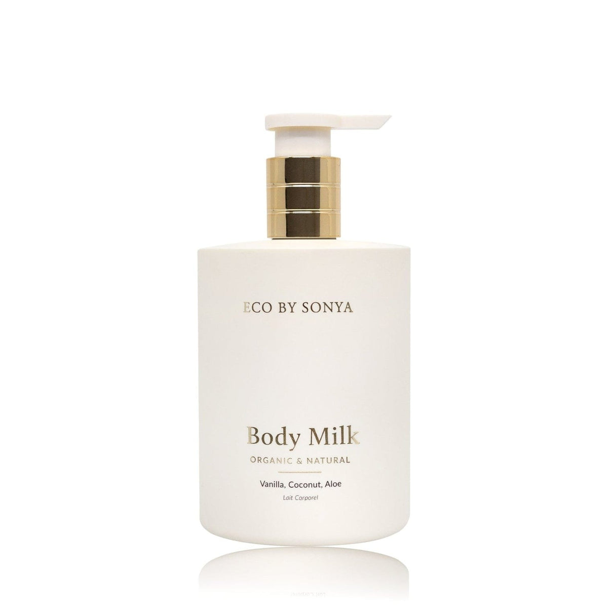 A white pump bottle of ECO BY SONYA Body Milk with a gold metallic collar and a white flip-top dispenser, set against a clean white background with a soft reflection below.