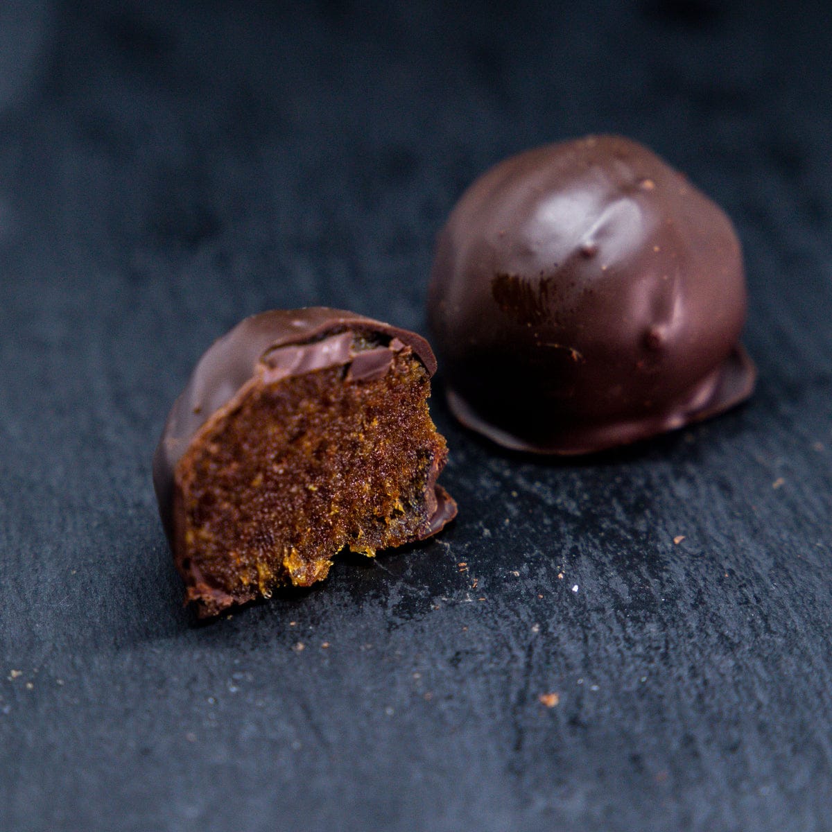 Chocolate truffles on a dark surface