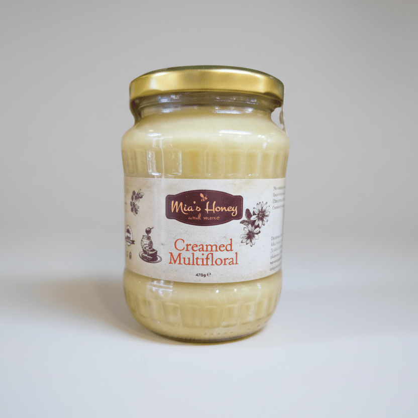 Jar of creamed multifloral honey with a label on a white background