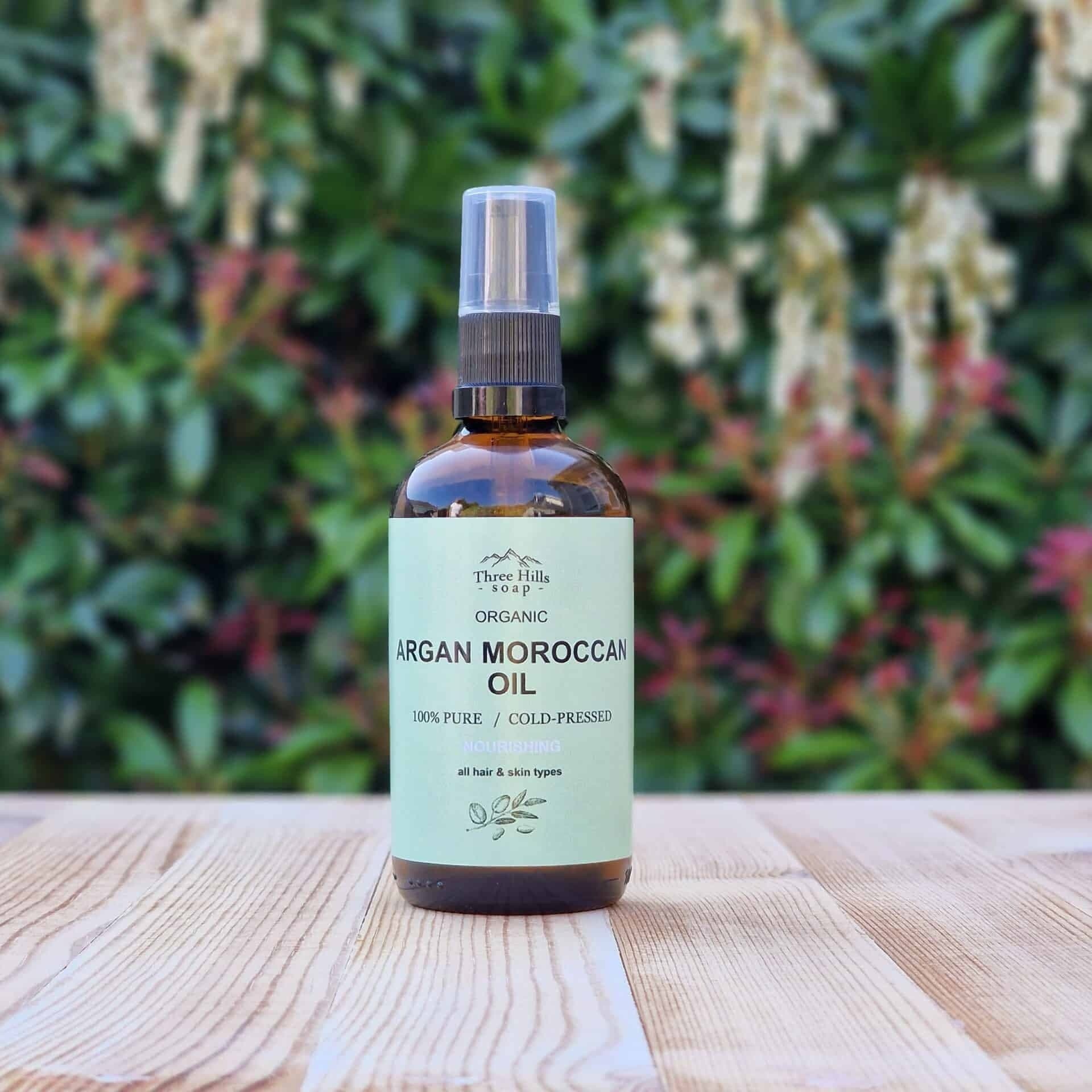 Bottle of argan Moroccan oil on a wooden surface with a natural background