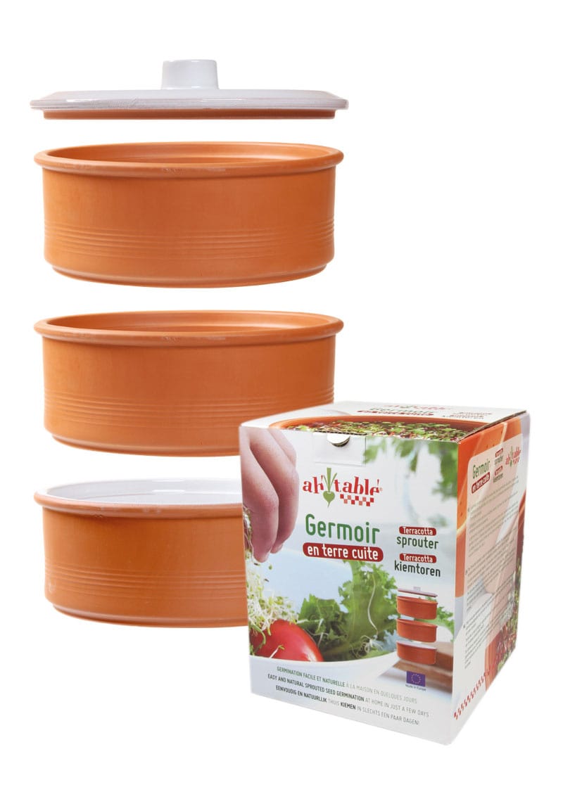 Set of terracotta-colored sprouting containers with a branded box on a white background