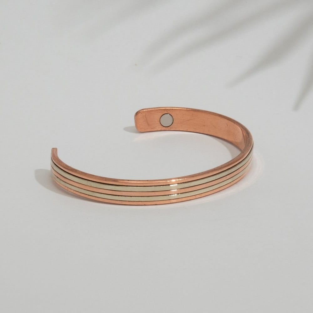 A copper and brass open cuff bracelet with 2 magnets