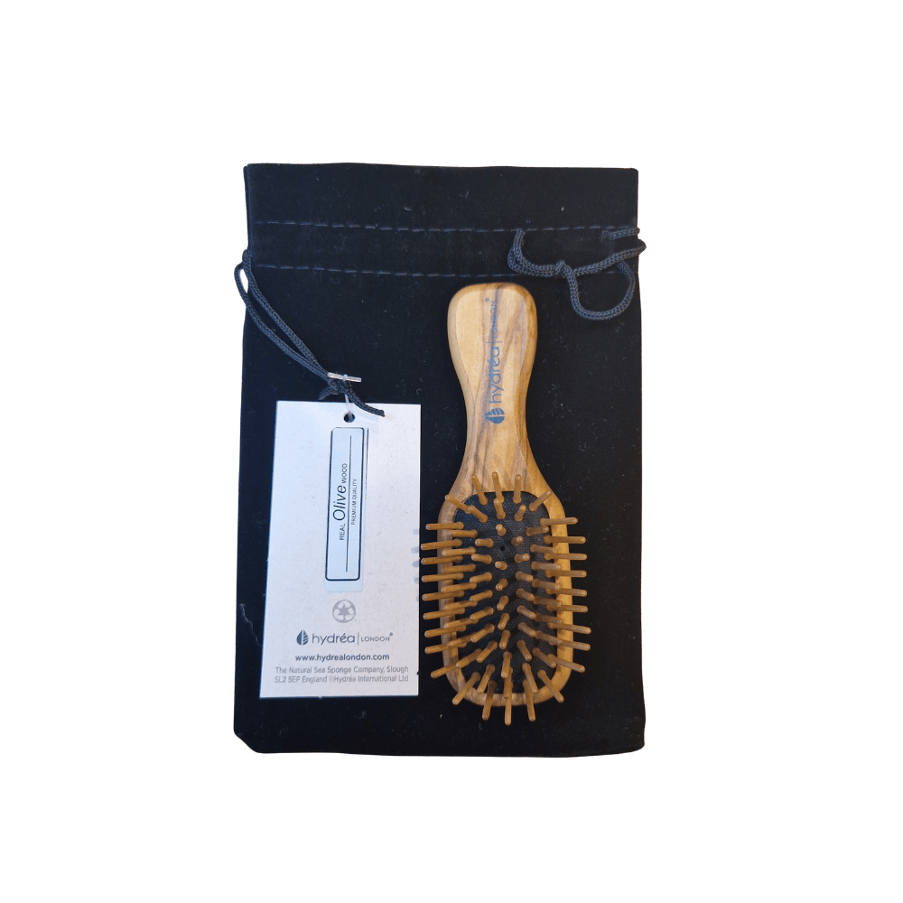 Wooden hairbrush in a black drawstring bag with a tag on a white background