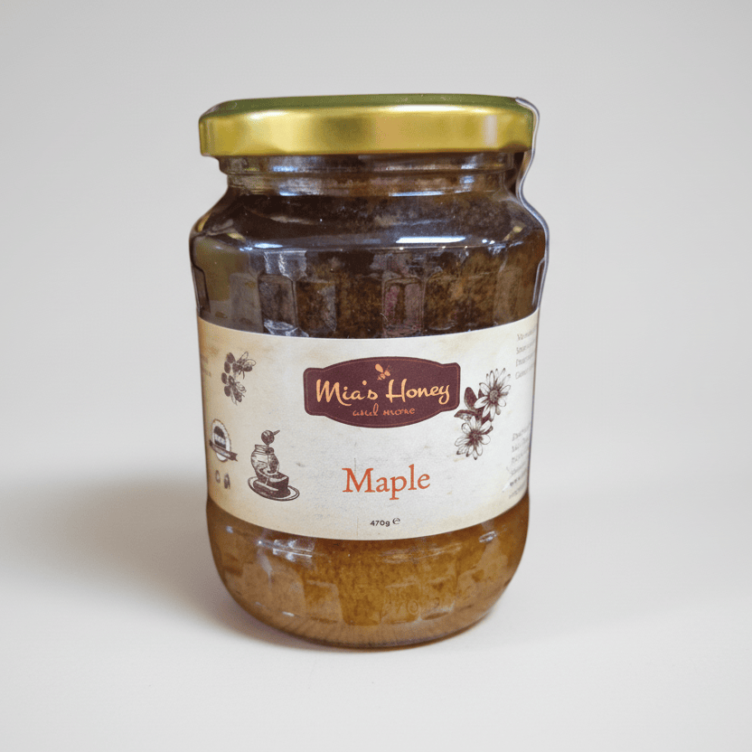 Jar of Mia's Honey with a gold lid on a white background
